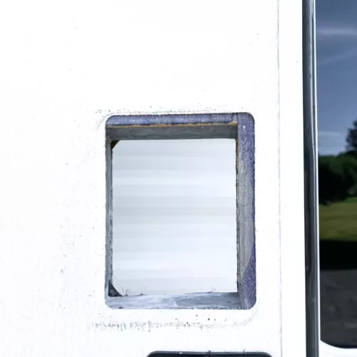 A close-up view of an RV door without a lock