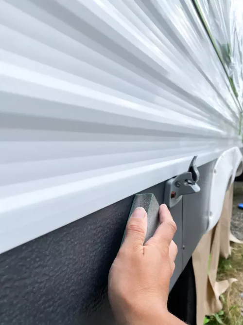 Sanding the exterior of an RV